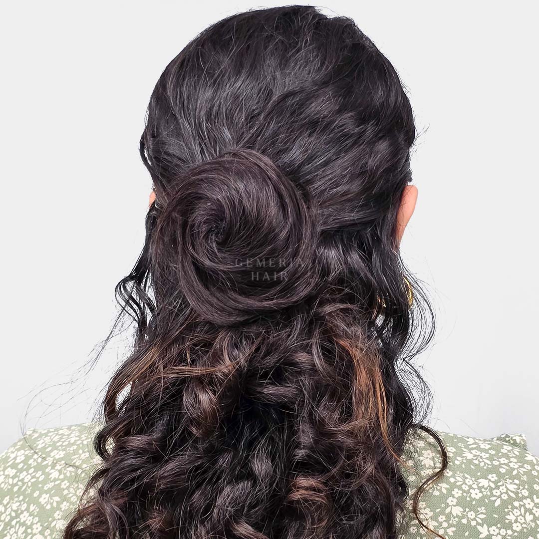 wearing a clip-on hair bun in long, curly hair with a half-up, half-down hairstyle