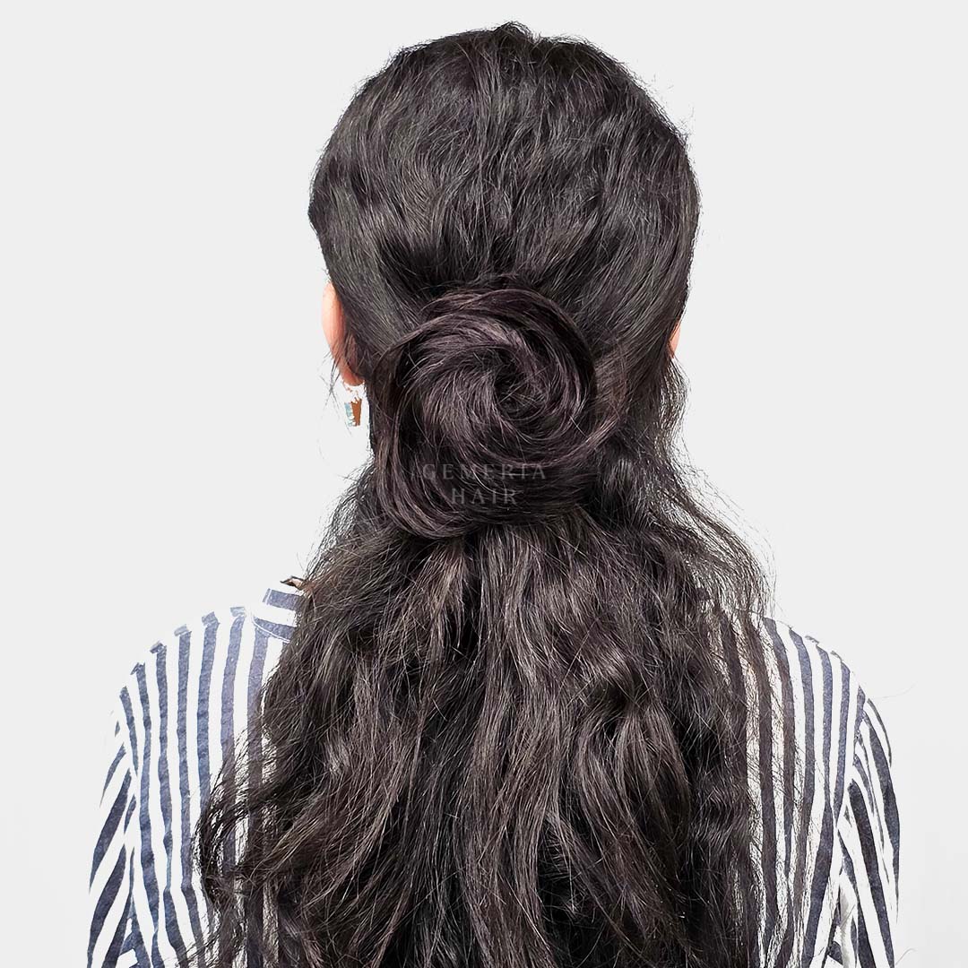 back view of wearing the clip-on hair bun in long hair, styled in a half-up, half-down hairstyle