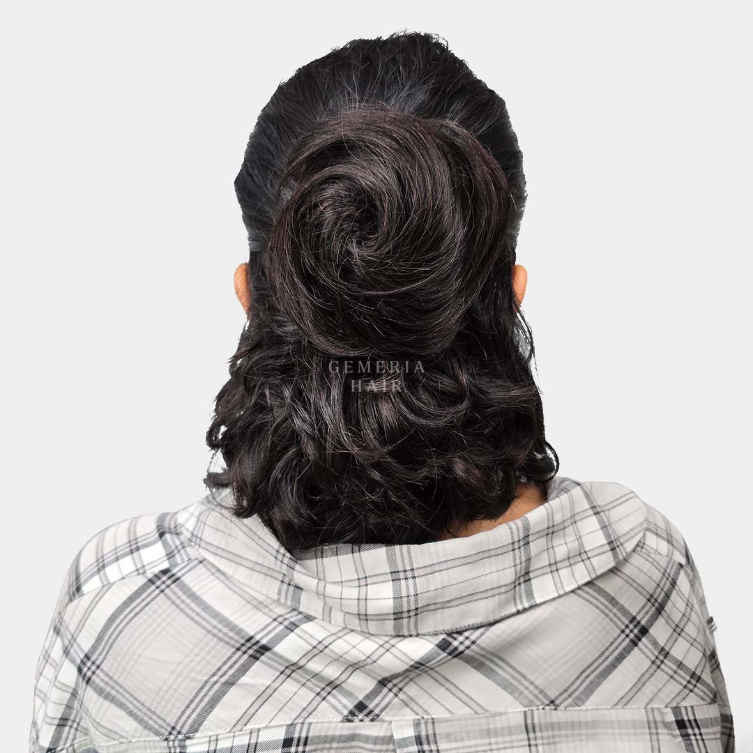 wearing a clip-on hair bun in a half-up, half-down hairstyle